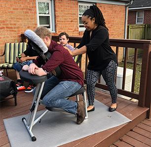 massage therapist giving a chair massage