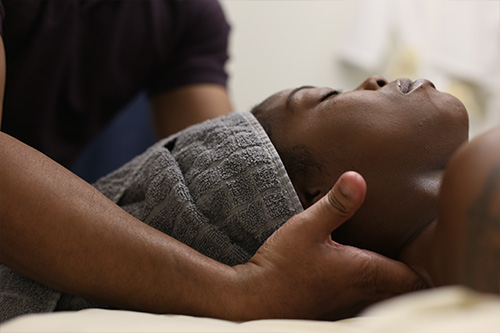 therapist massaging woman's neck